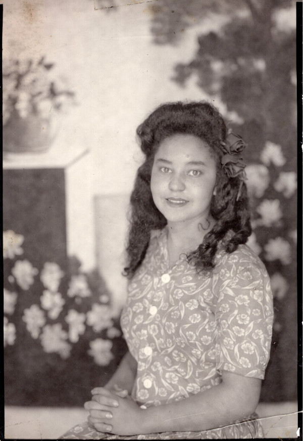 Woman in floral backdrop by Unknown