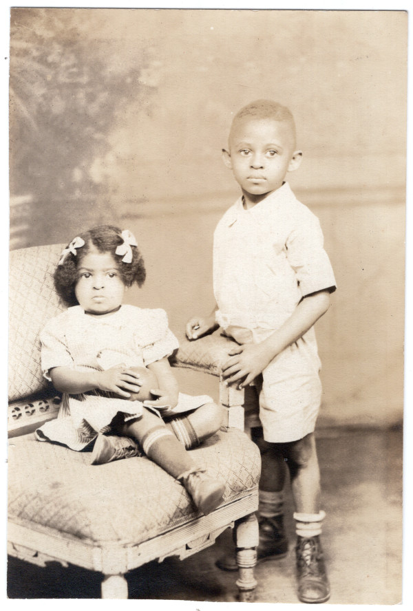 Seated girl & standing boy by Unknown