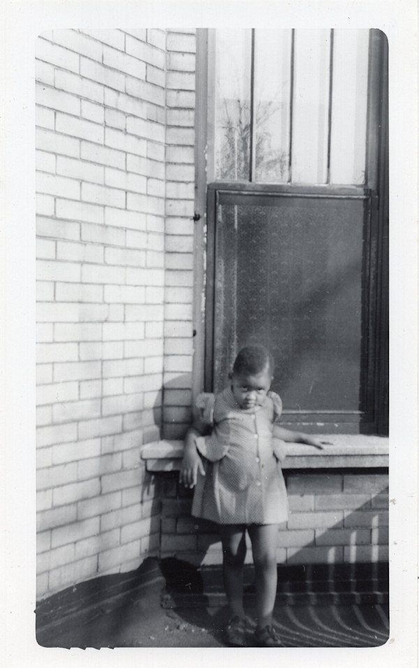 Girl leaning against sill by Unknown