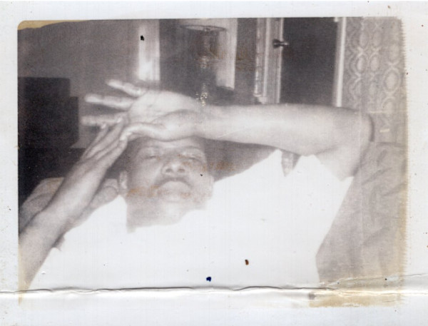 Man with hands above his head by Unknown