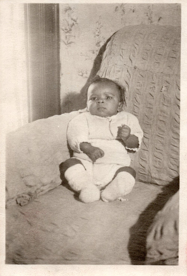 Infant in chair by Unknown