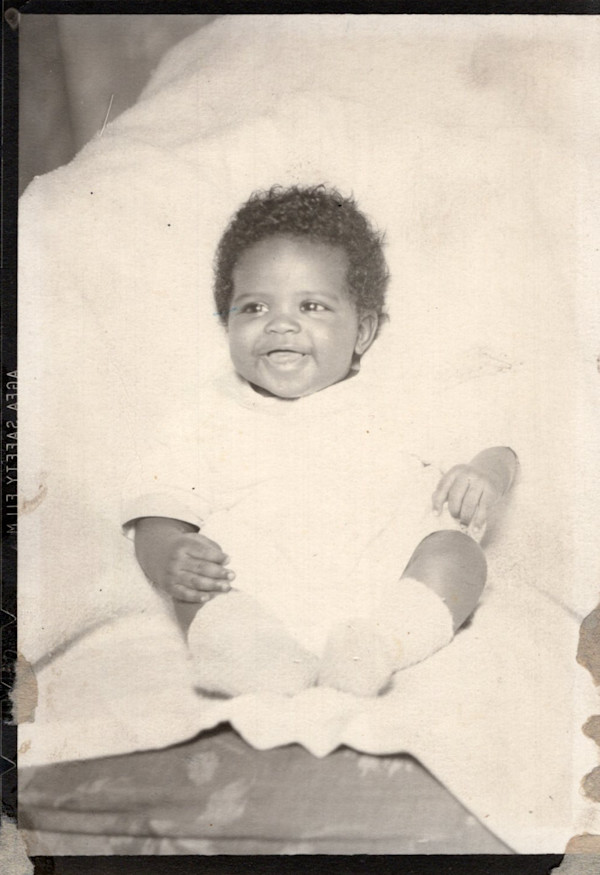 Infant in chair by Unknown
