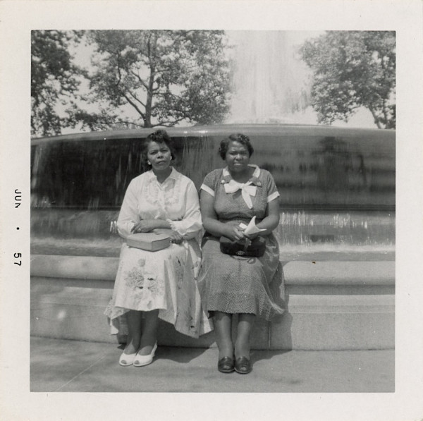 Lillie Estes Starks and friend sitting by fountain by Unknown