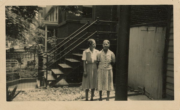 Two women near outdoor stairs by Unknown