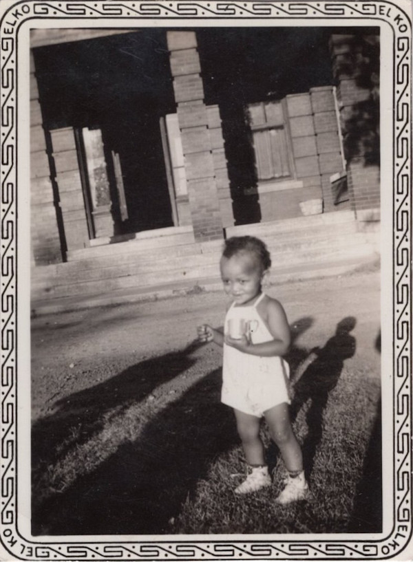 Kewpie toddler holding cup by Unknown