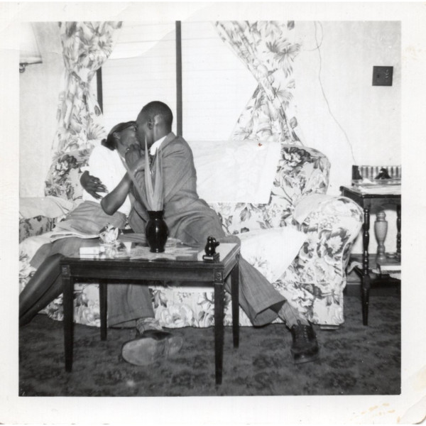 Couple kissing on sofa by Unknown