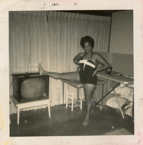 Woman with leg up on television by Unknown