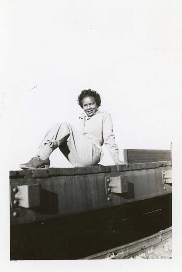 Woman posing on railroad tracks? by Unknown