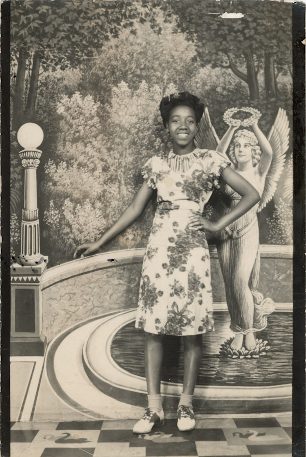 Girl in front of fountain backdrop by Unknown