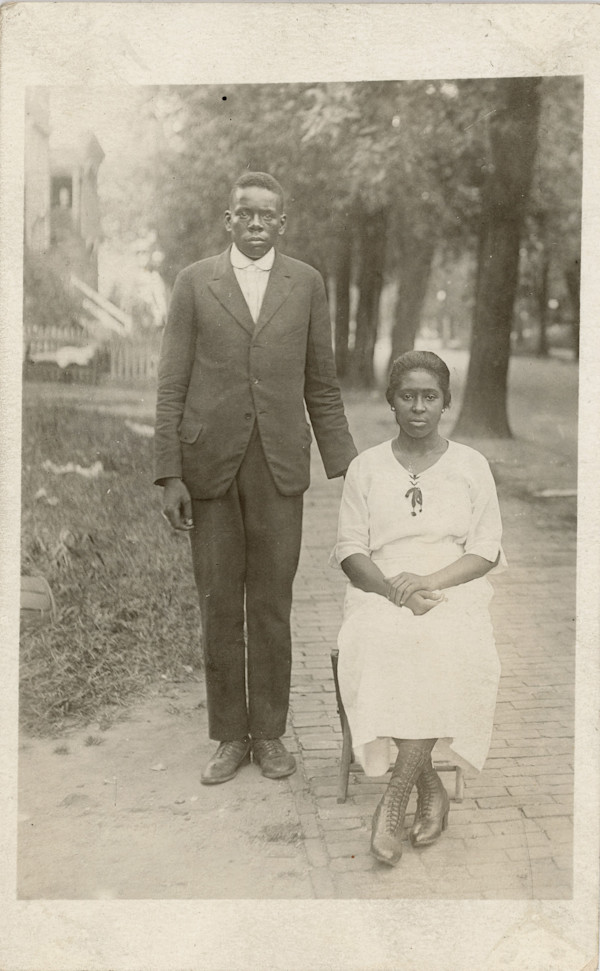 Couple posing at the sidewalk by Unknown