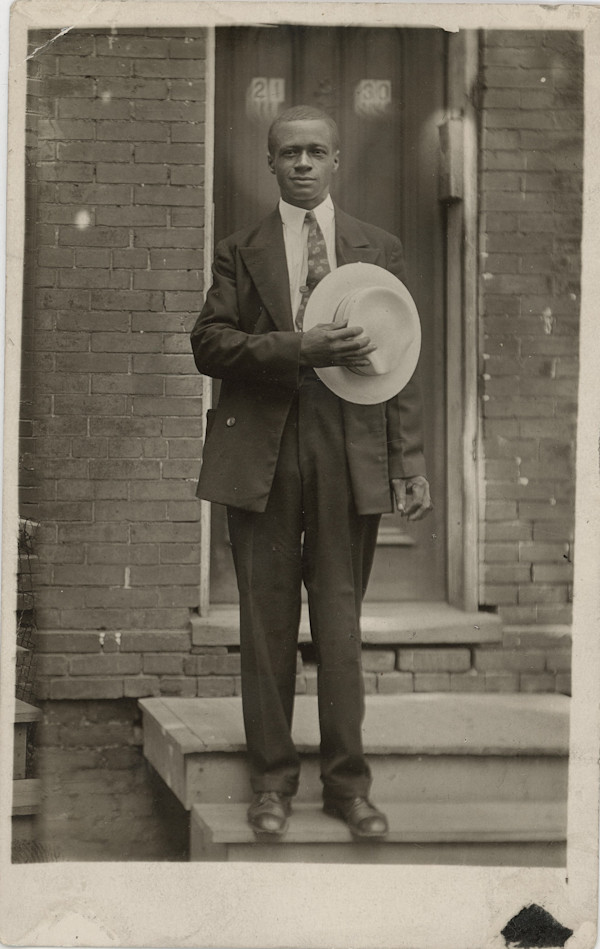 Man holding hat over his heart by Unknown