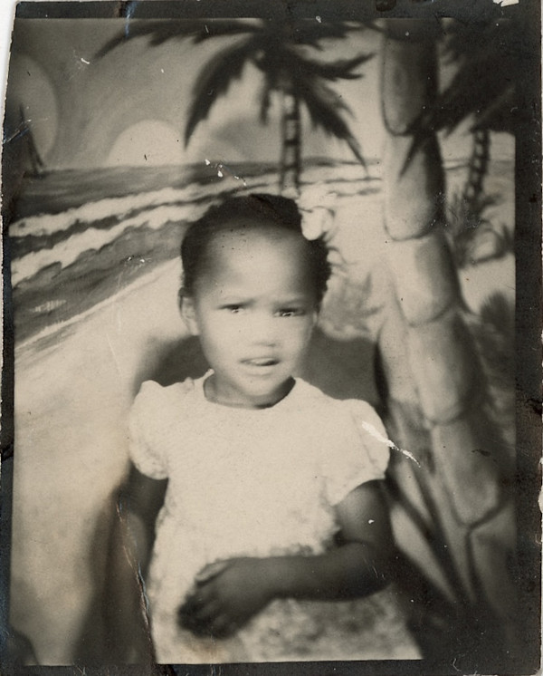 Young girl with beach backdrop by Unknown