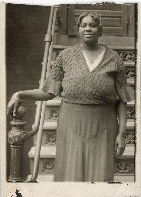 Woman standing at bottom of steps by Unknown