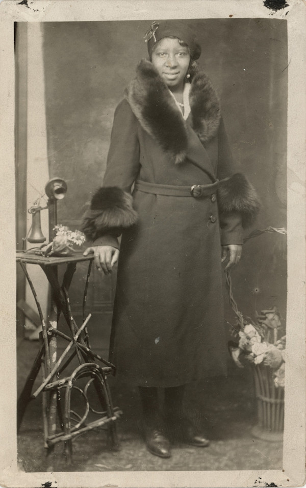 Woman in fur-trimmed coat by Unknown