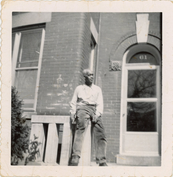 Man sitting on front stoop at 61 Bryant St NW by Unknown