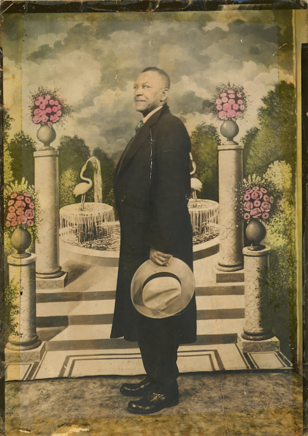 Man holding his hat by Unknown