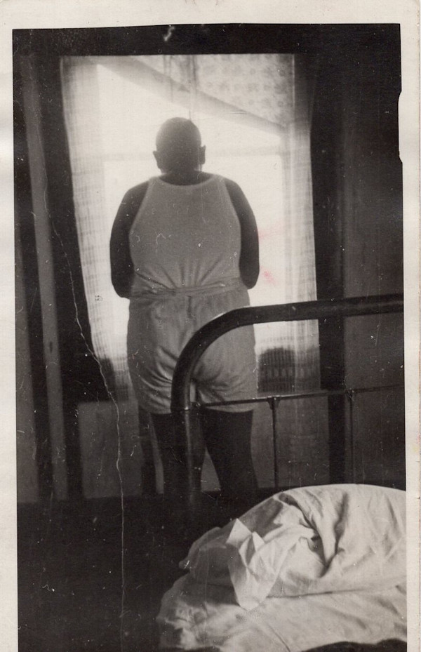 Man in his underwear standing at the window by Unknown