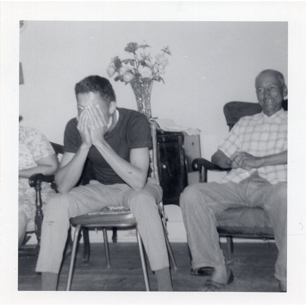 Man hiding his face with his hands by Unknown