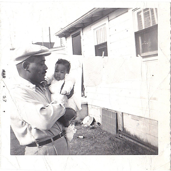 Man holding baby by Unknown