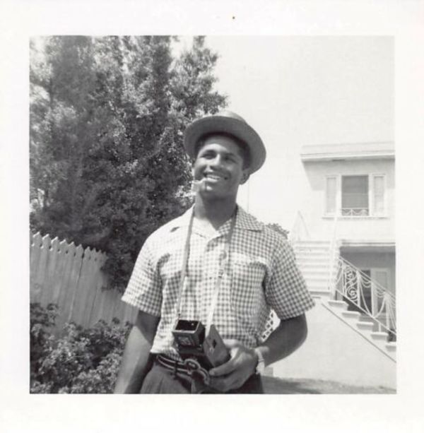 Smoking man holding twin lens reflex camera by Unknown