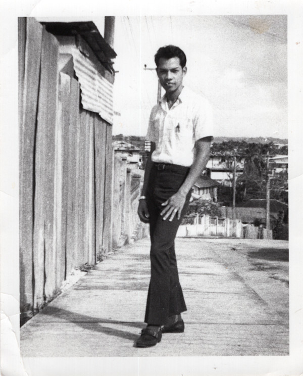 Man posing on sidewalk by Unknown
