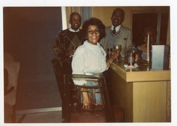 Group around home bar by Unknown