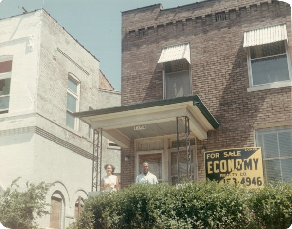 Martha and Louis standing on porch of house for sale by Unknown