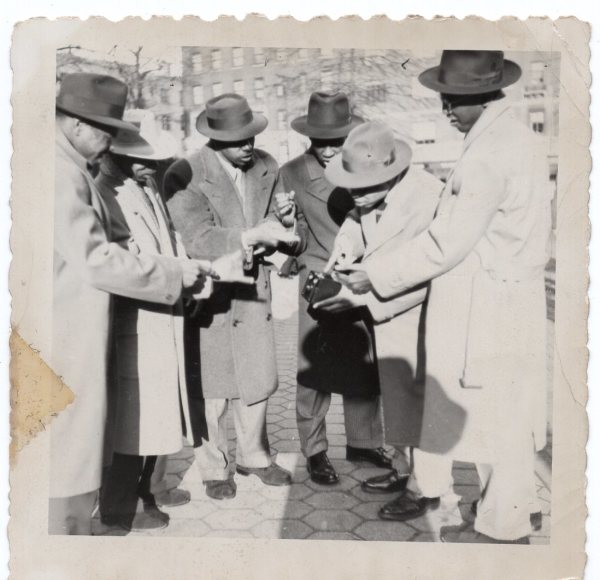 Men discussing box camera by Unknown