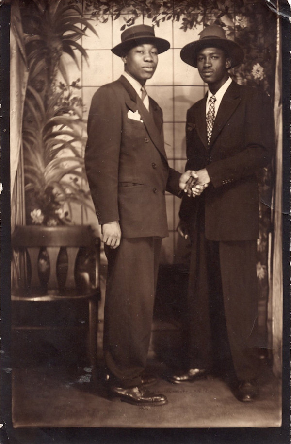 Two men holding hands by Unknown