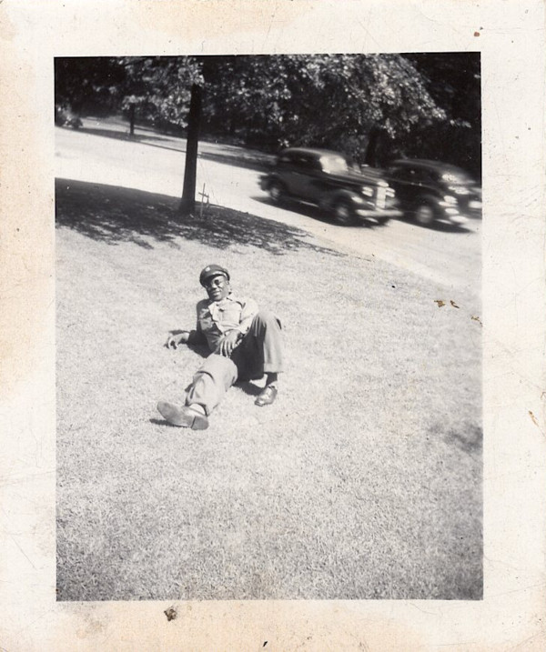 Soldier lounging on grass by Unknown