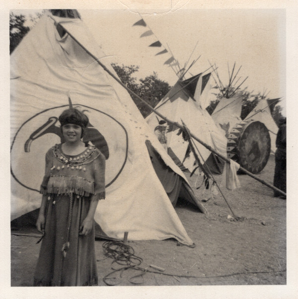 Native girl with teepees by Unknown
