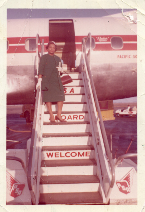 Woman standing outside of Pan American airplane by Unknown