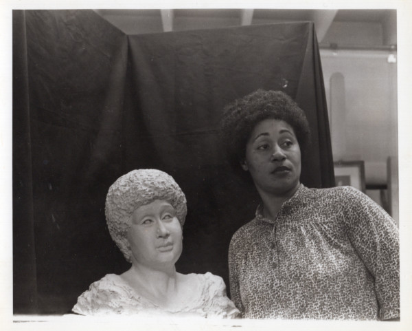 Woman with sculpture bust likeness by Unknown
