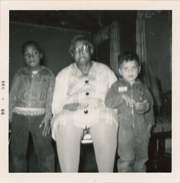 Older woman with two boys by Unknown