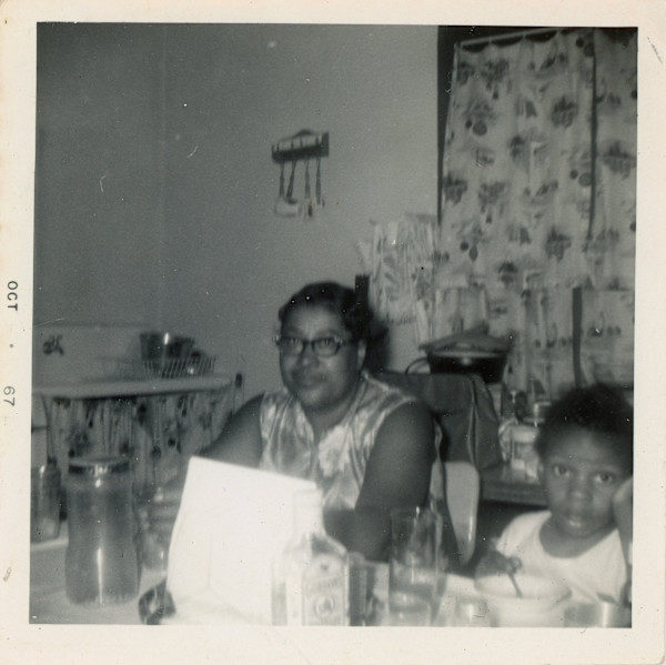 Woman and child in the kitchen by Unknown