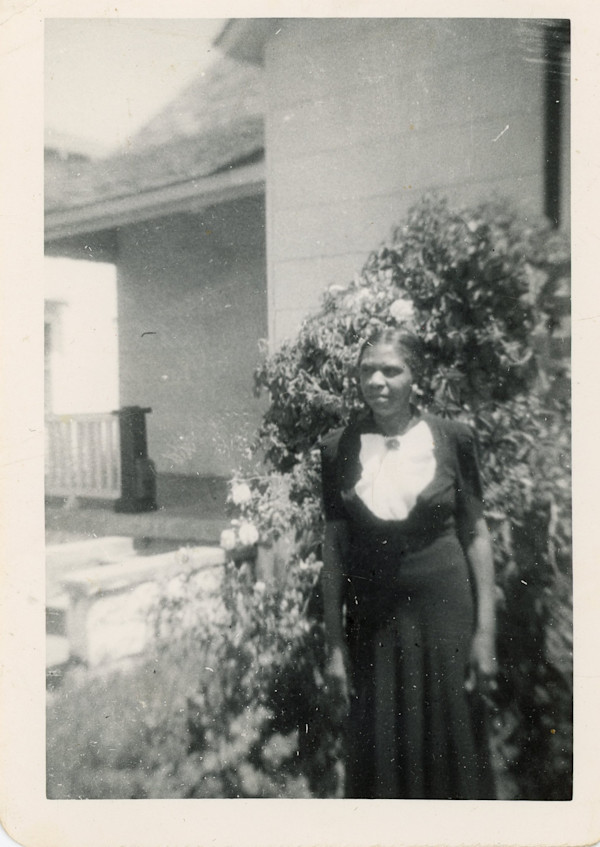 Woman in dark dress with white bib by Unknown
