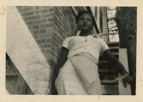 Woman descending outdoor stairs by Unknown
