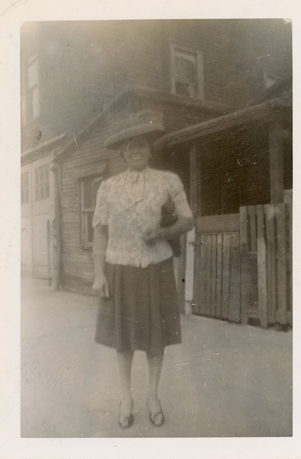 Woman standing on the street by Unknown