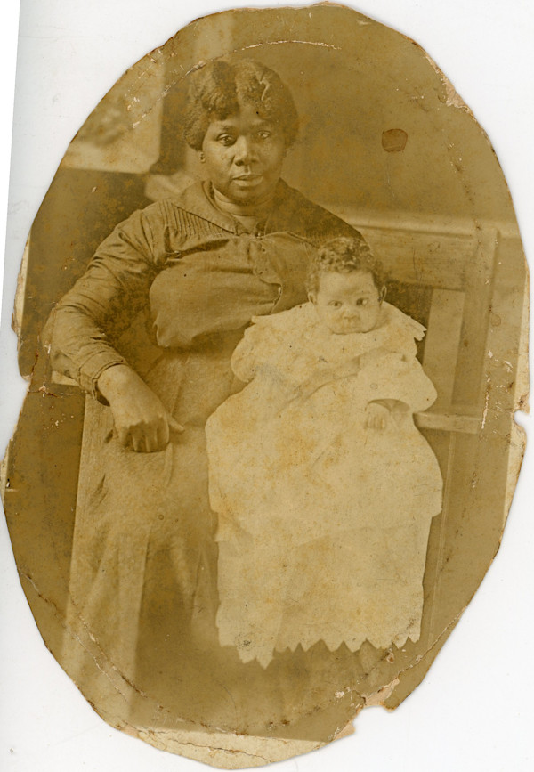 Woman holding infant by Unknown