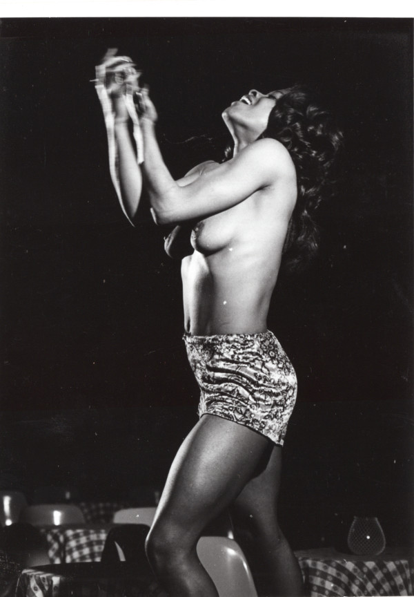 Burlesque dancer in club by Unknown