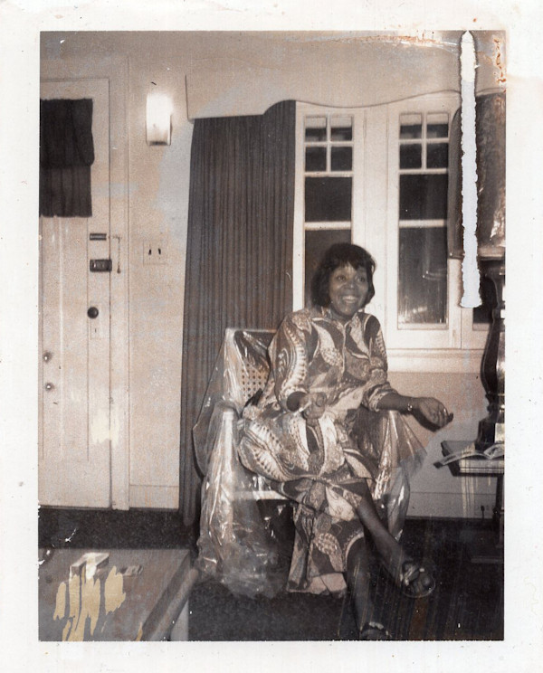 Woman sitting on plastic-covered chair by Unknown