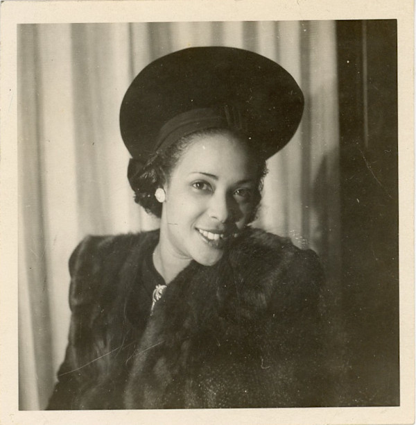 Woman in fur-collared coat and hat by Unknown