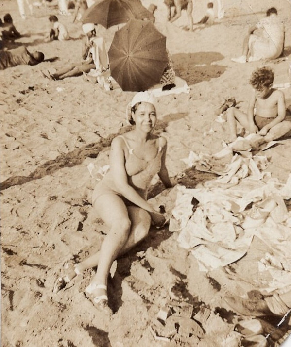 Woman reclining on the beach by Unknown