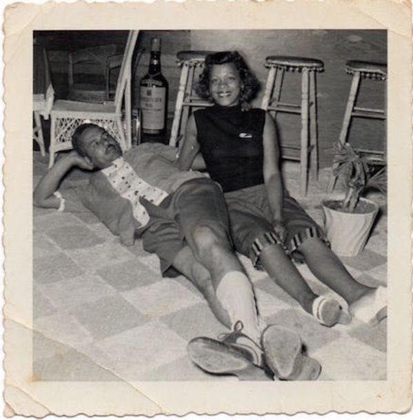 Man & woman reclining on barroom floor by Unknown