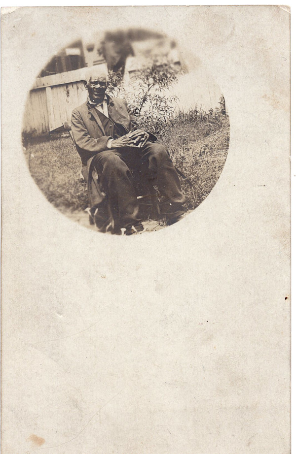 Elderly man seated outside by Unknown