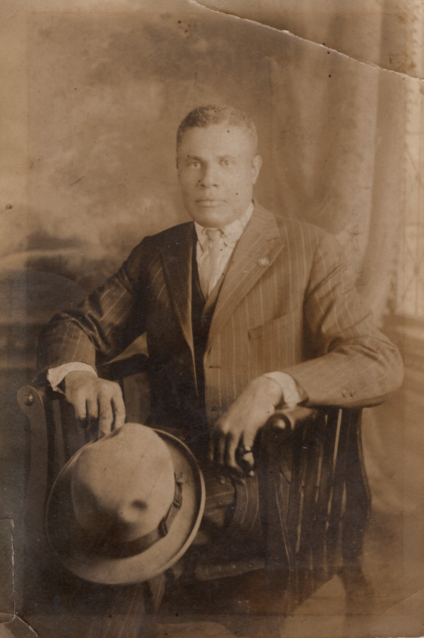 Seated man holding hat by Unknown