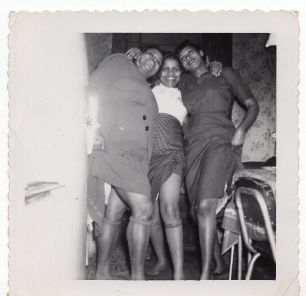 Three women showing legs by Unknown
