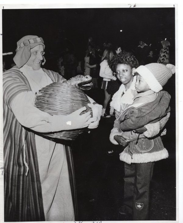 Snake Charmer John Dearing amazes Tyrium and Ruby Carter along the route of the Shangri-La Parade, Mardi Gras, Chalmette-Arabi by Unknown