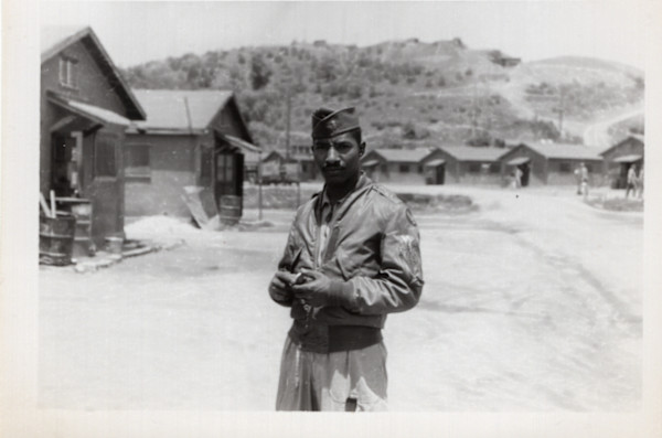 Soldier standing in camp by Unknown