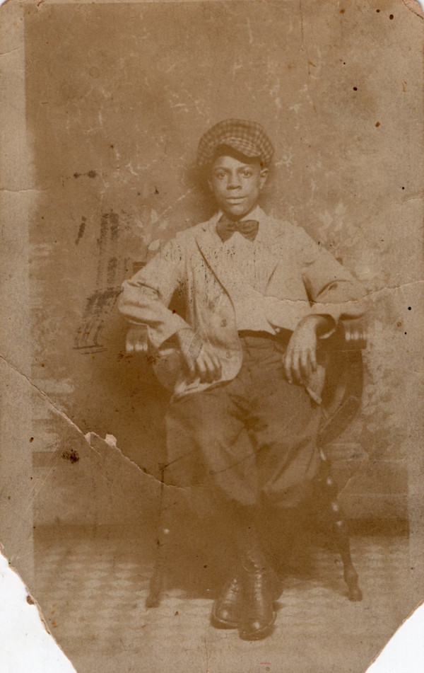 Young boy in checked cap by Unknown